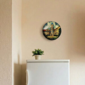 A large, round vintage enameled wall plate depicting the City Tower of Rijeka in vibrant textured colors like ochre, terracotta, and blue. Flawless estate condition, shown hanging on a wall in a lifestyle setting and in a close-up studio shot.