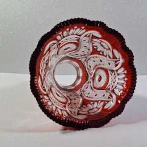 Hand-cut ruby red cased lead crystal lampshade with intricate star and floral patterns, showing deep engravings and heavy glass structure.
