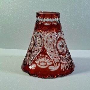 Hand-cut ruby red cased lead crystal lampshade with intricate star and floral patterns, showing deep engravings and heavy glass structure.